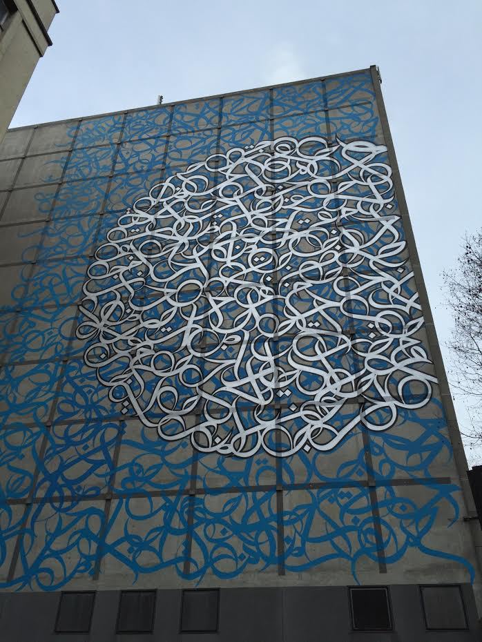 eL Seed mural on Jean Nouvel’s Institut du Monde Arabe in Paris. Reads: “Love is the miracle of civilisations” .